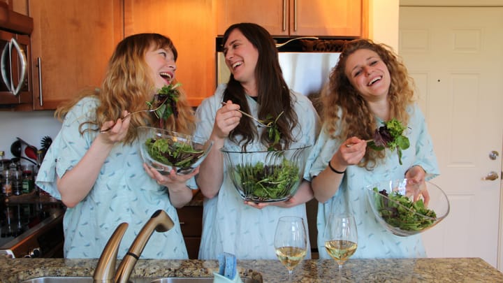 The members of Childbirth, laughing with salad (and also white wine).