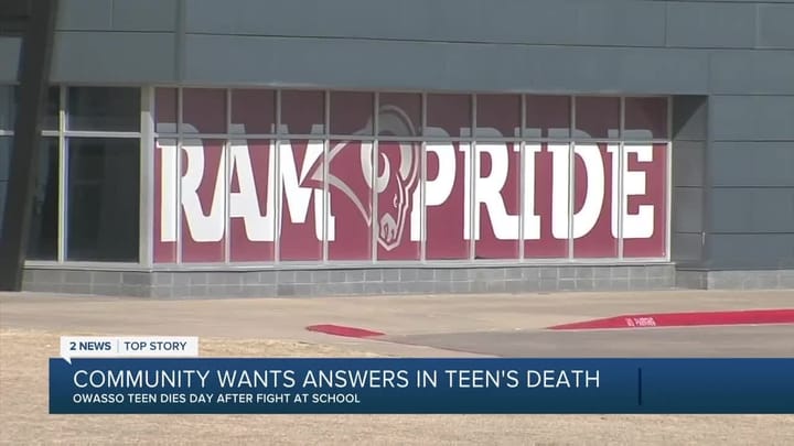 A big RAM PRIDE sign hangs in the window of Owasso High School, over a news chyron about Nex Benedict's death.